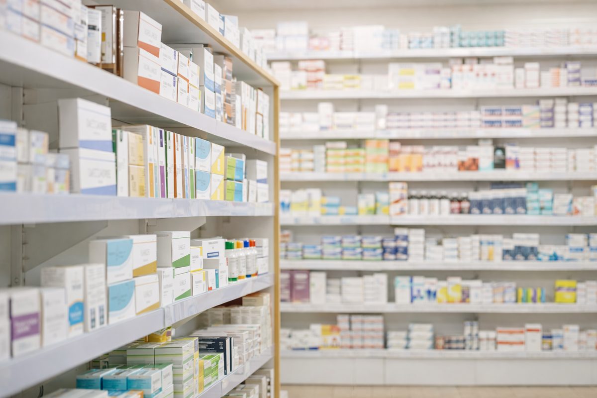 Neatly stocked shelves of health and wellness products in an Australian community pharmacy.